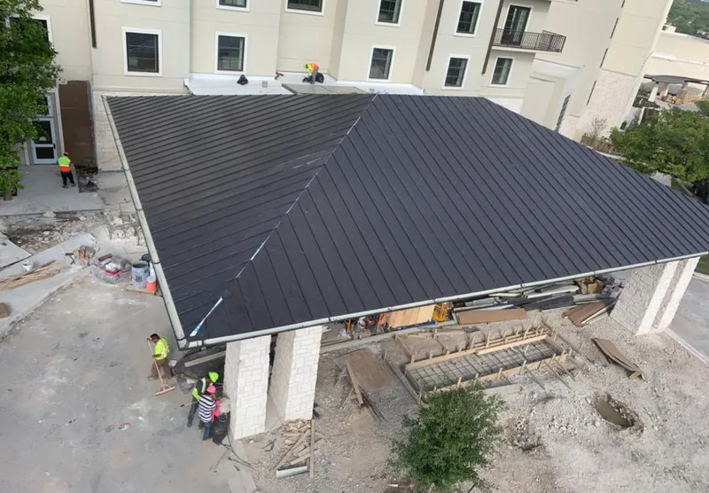 Metal roofing installation team working on a commercial building in Joshua Tree